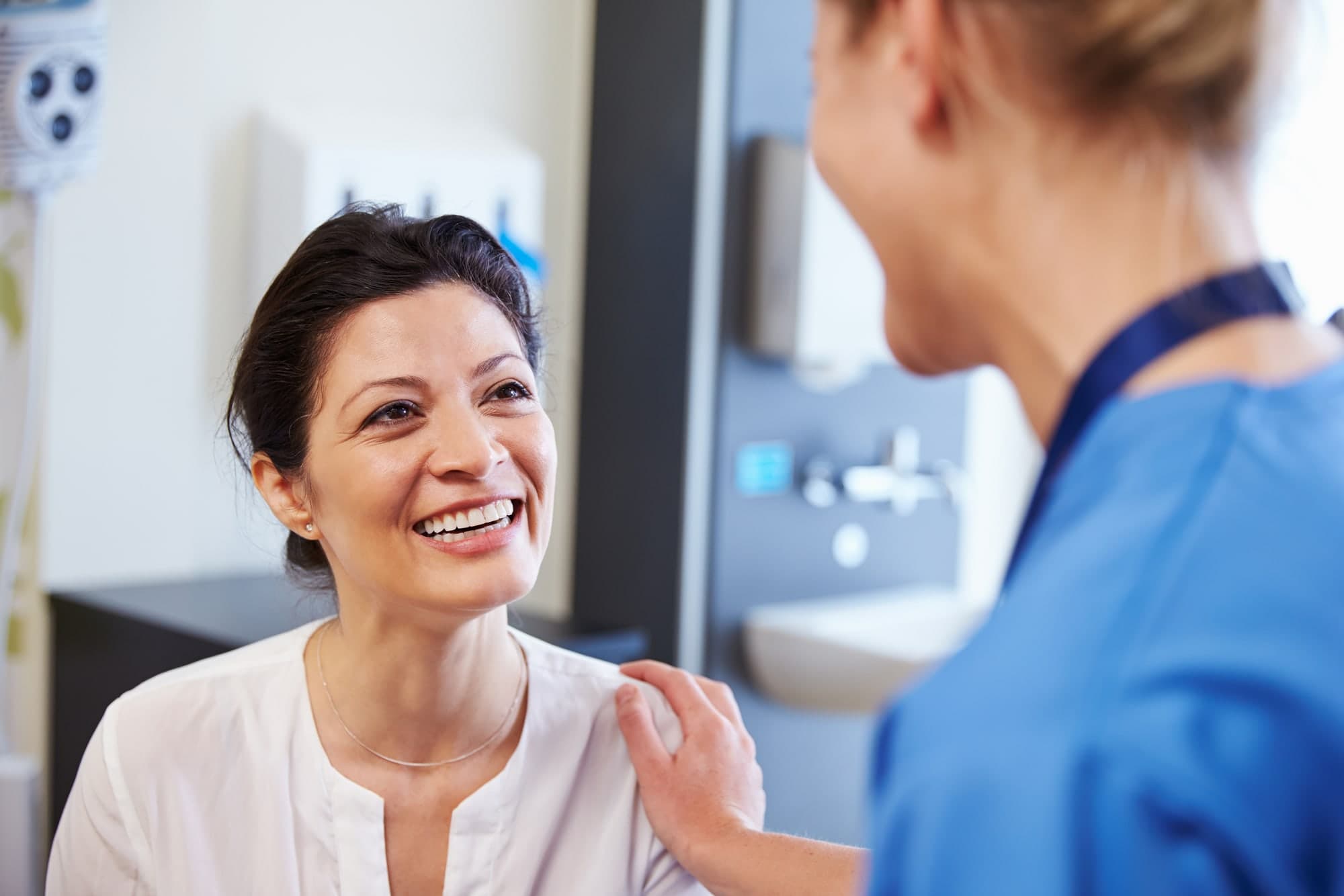 A smiling patient with her doctor